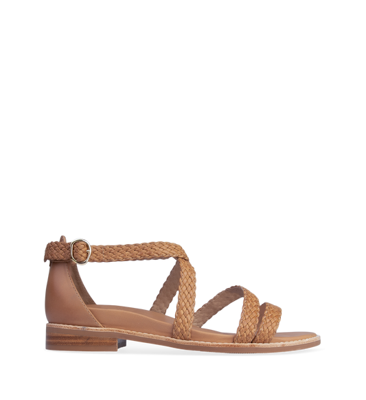 A tan leather flat sandal with adjustable buckle strap and a low heel.