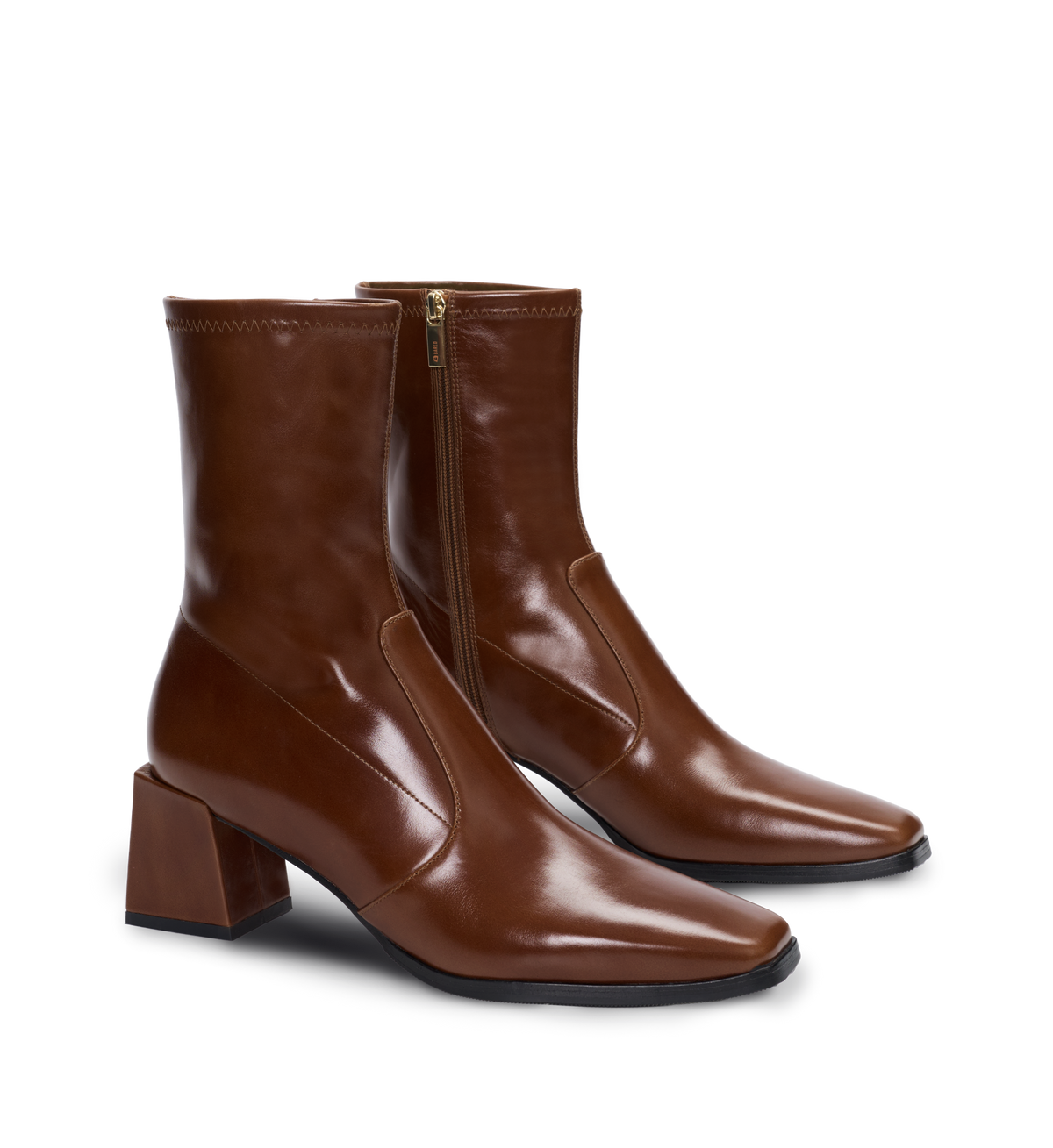 Pair of brown leather ankle boots on a white background