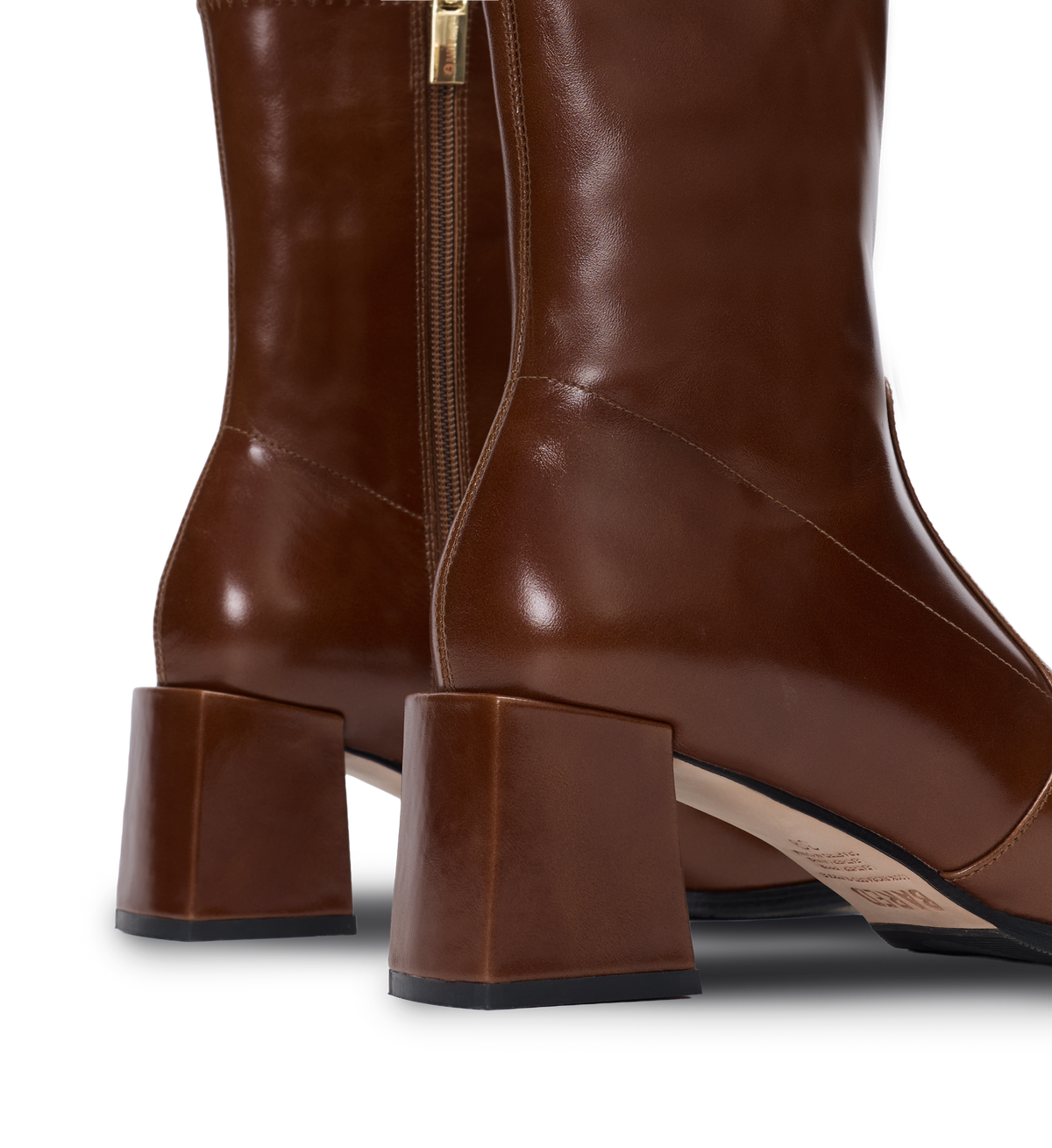 Brown leather knee-high boot with a block heel on a white background