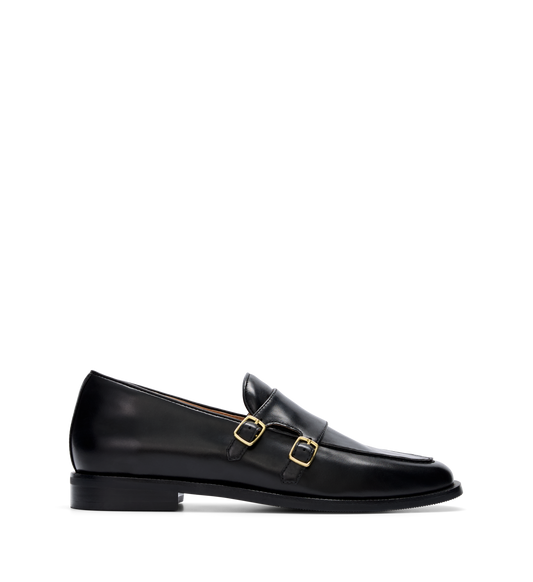 A womens black leather monk shoe with a double strap and gold hardware.