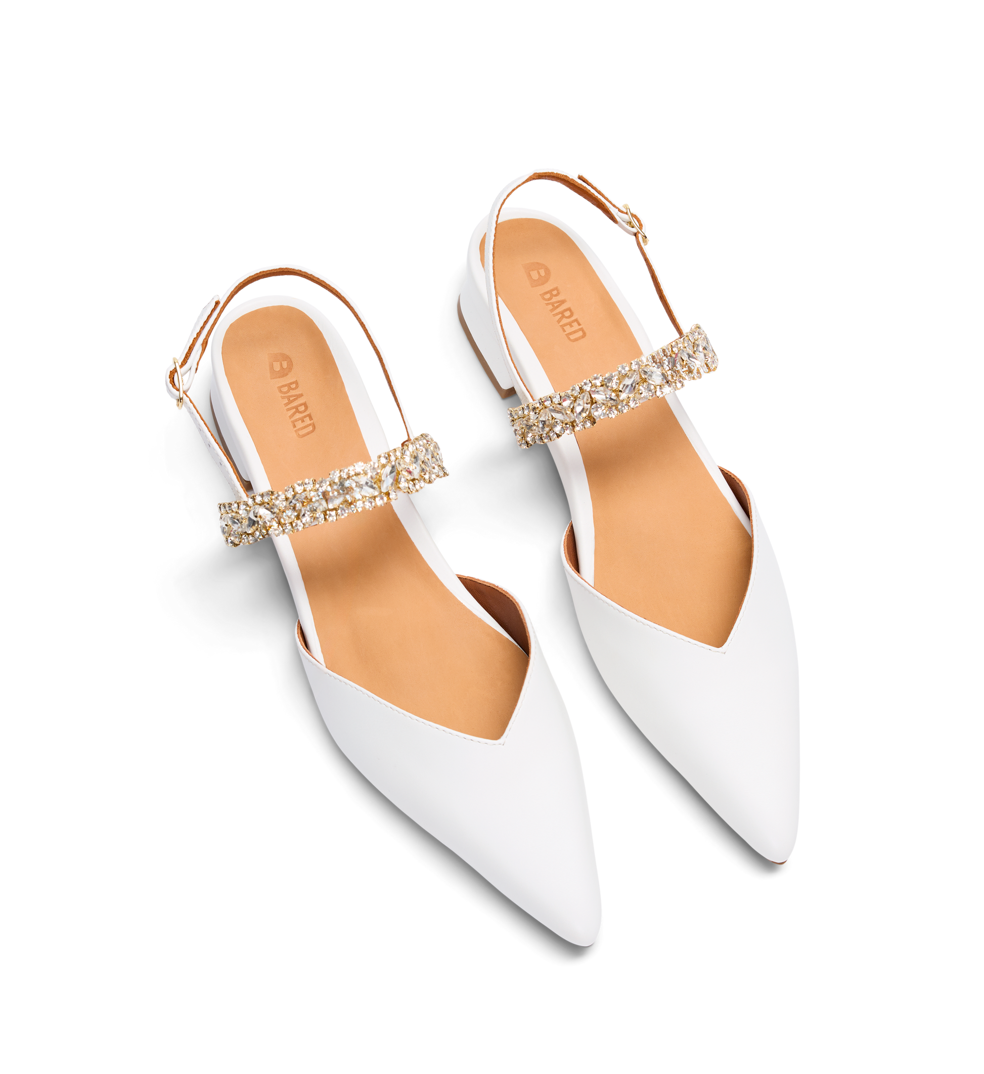 White pointed-toe shoes with gold embellishments on a white background