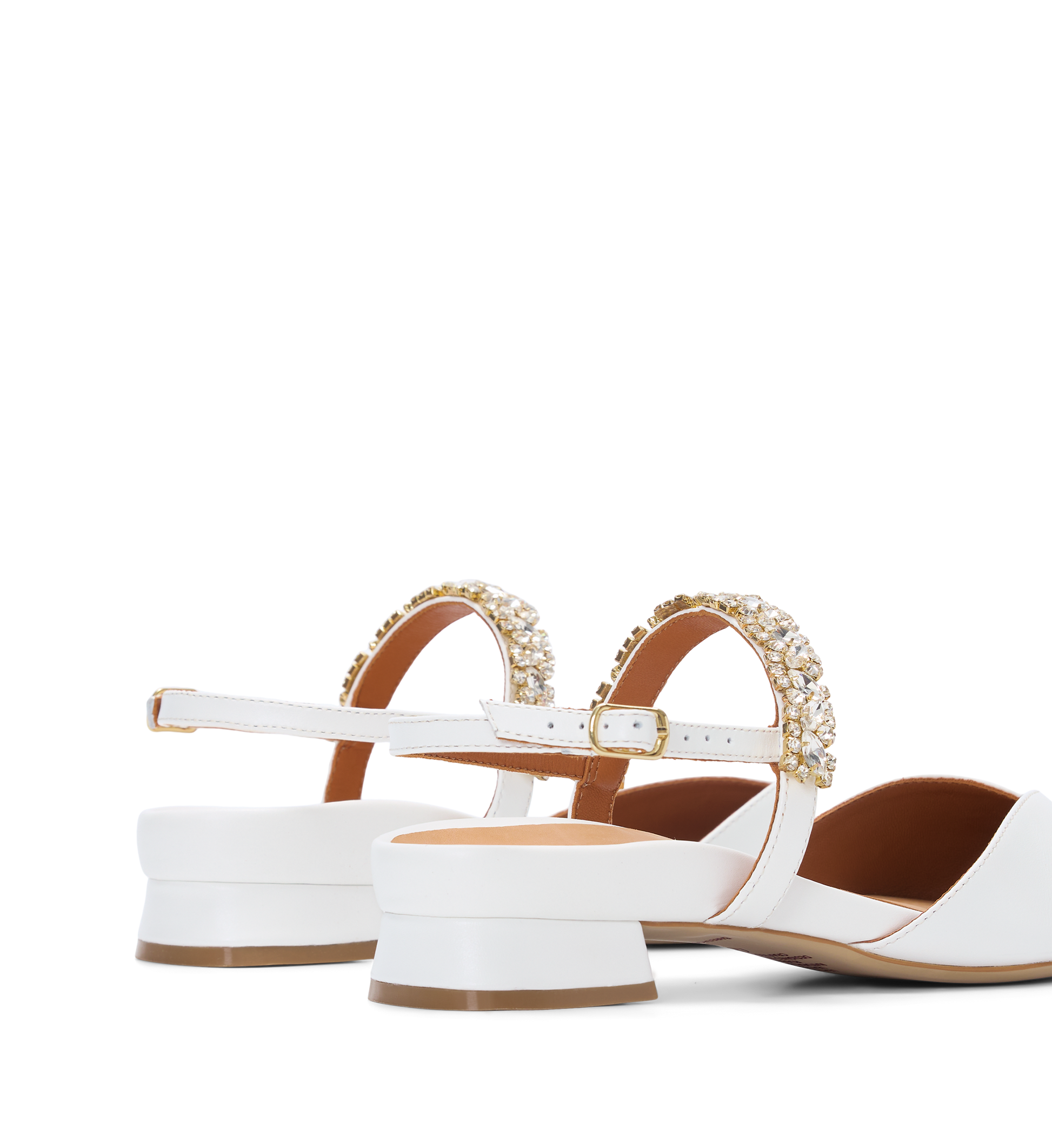 White flats with gold embellishments on a white background