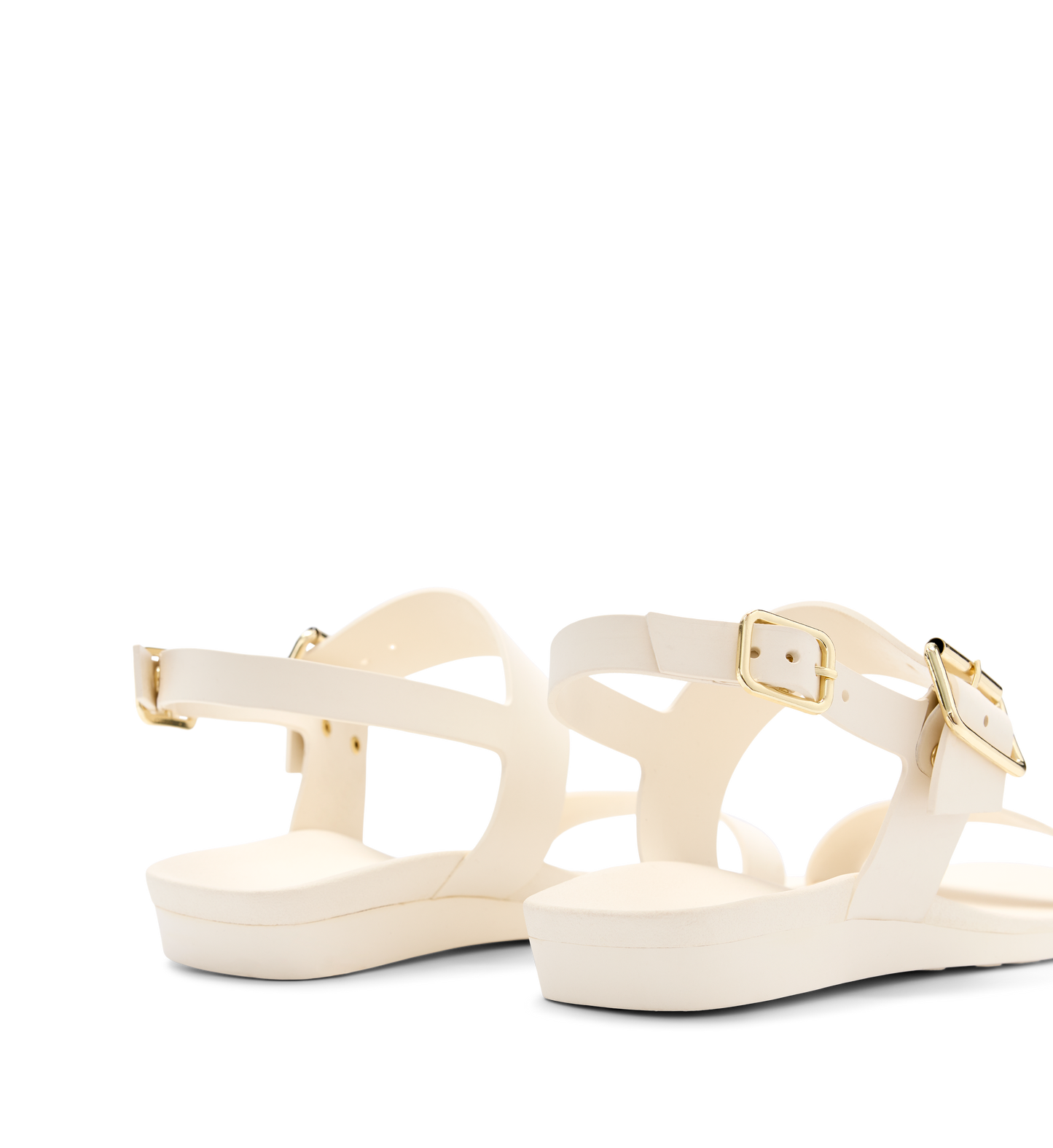 white sandals with adjustable straps and gold buckles