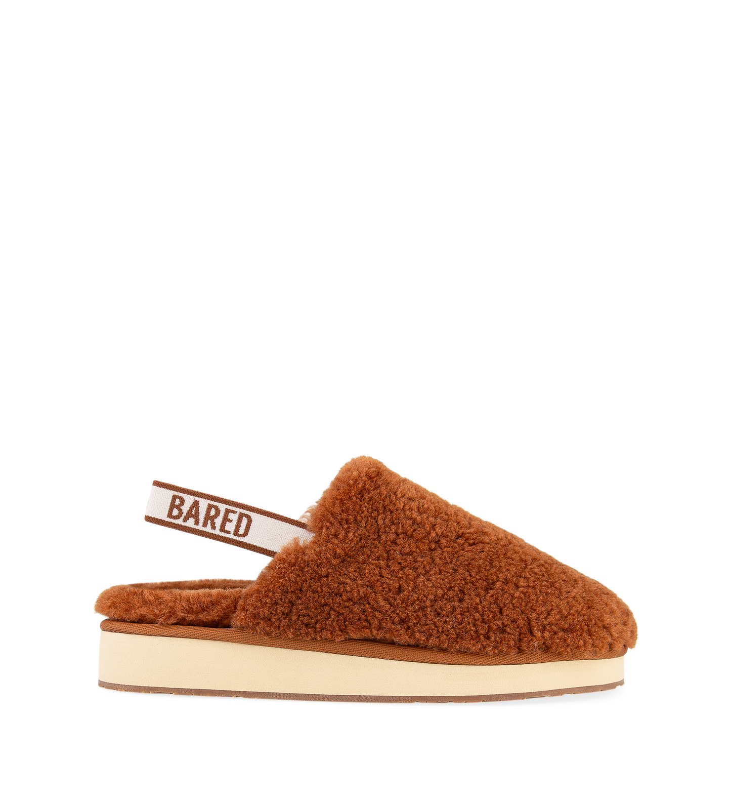 A brown sheepskin slipper with an elastic sling-back strap and the brand name 'BARED' visible on the strap.