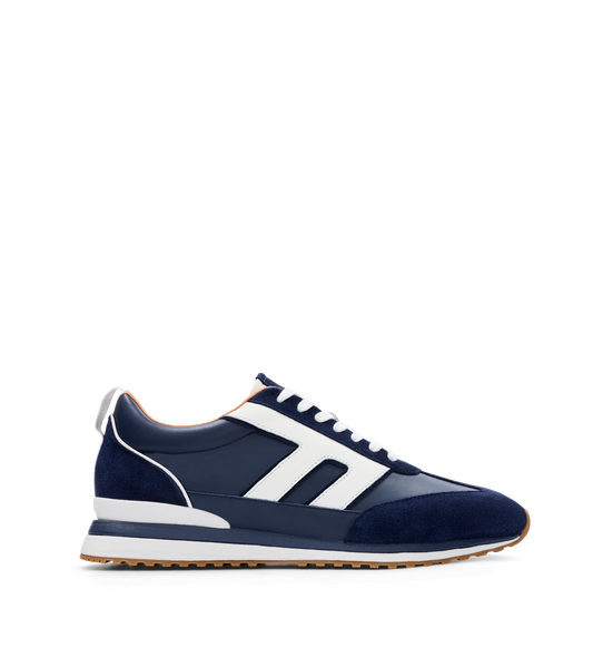 A navy leather and suede sneaker with white detailing and a rubber outsole.