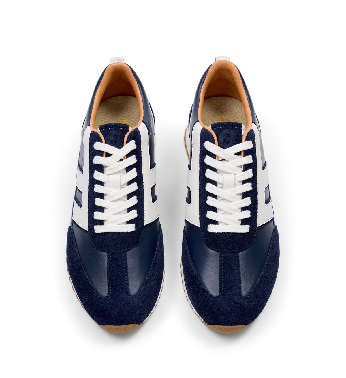 pair of navy suede sneakers with white laces 