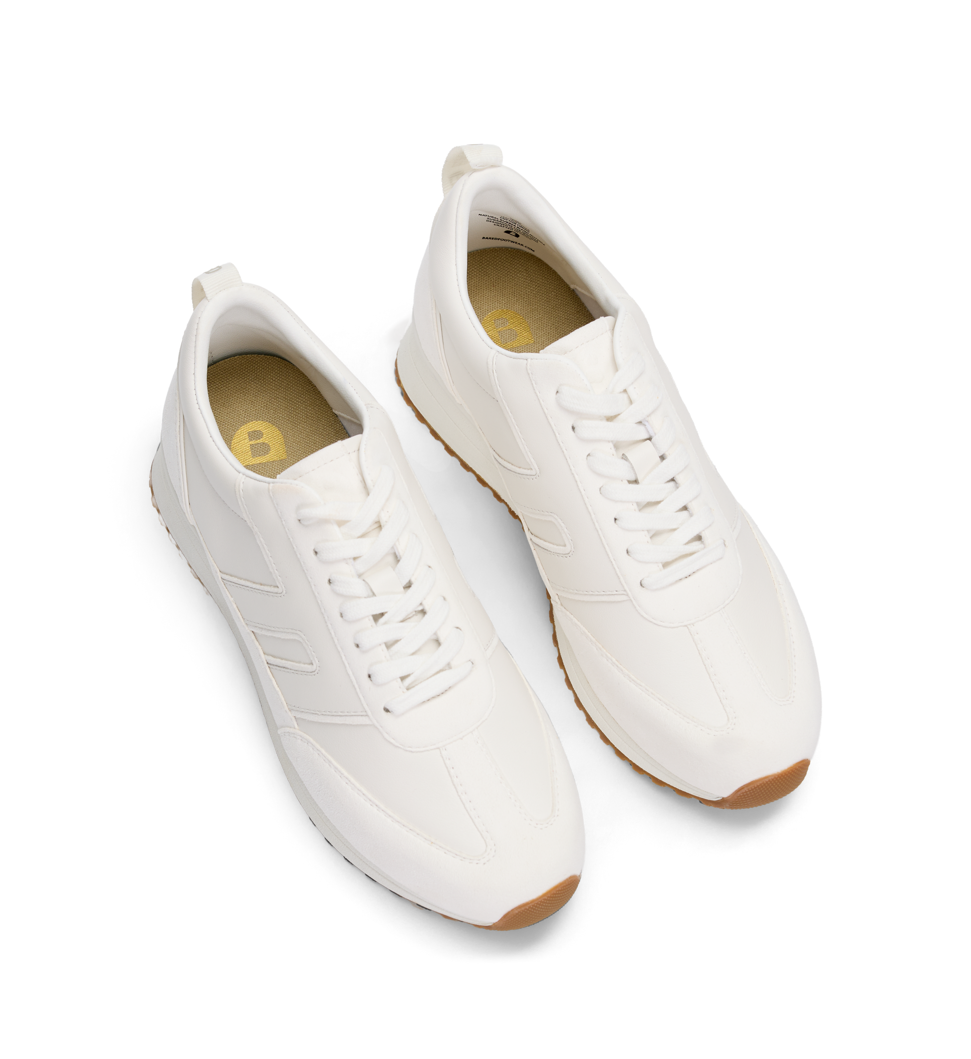 Pair of white sneakers with brown soles on a white background