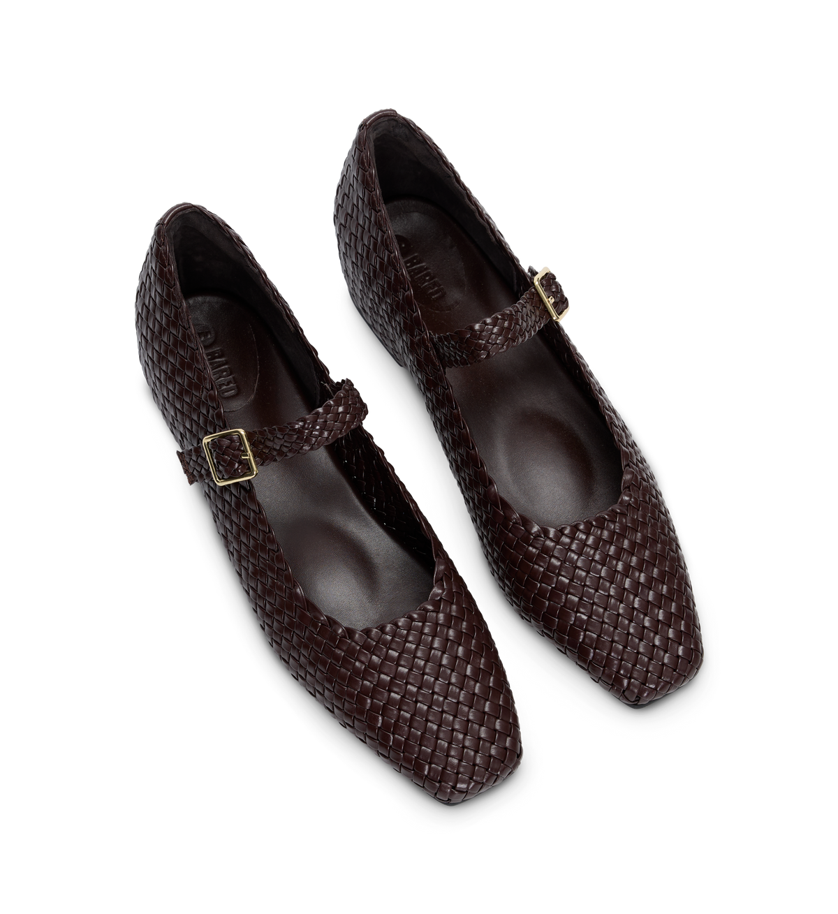Pair of brown woven ballet flats with buckles on a white background
