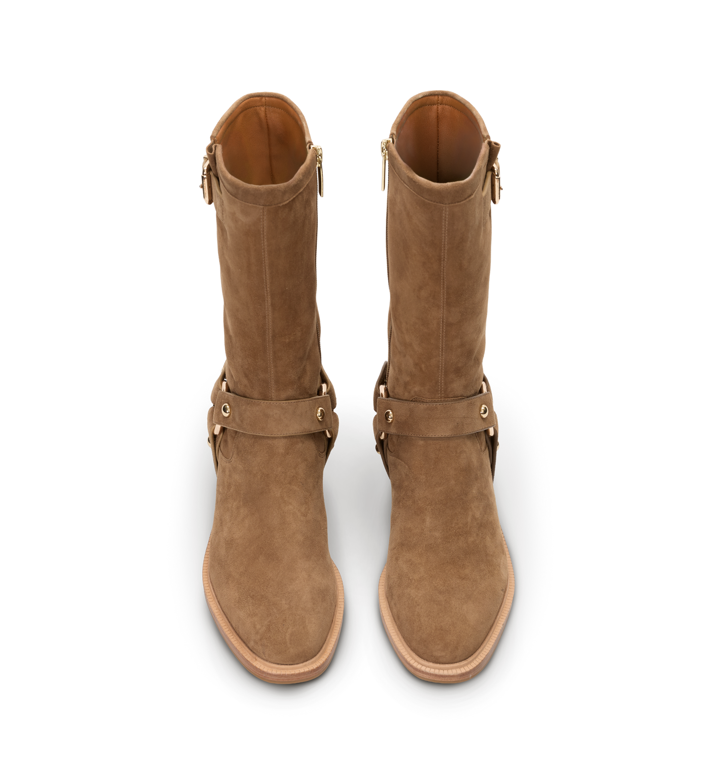 Pair of brown suede boots with straps on a white background