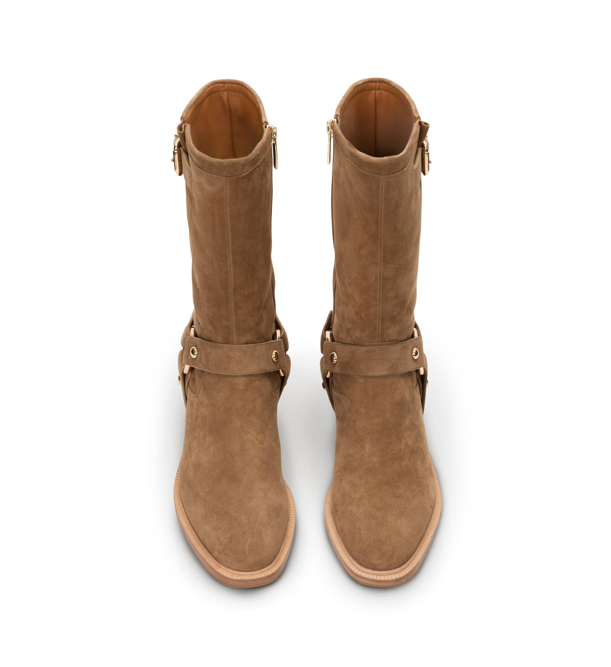 Pair of brown suede boots with straps on a white background