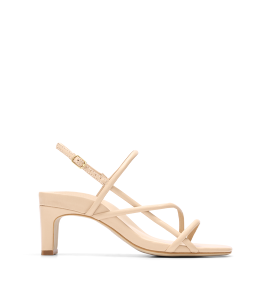 A beige strappy low heel sandal with an ankle strap and gold hardware.