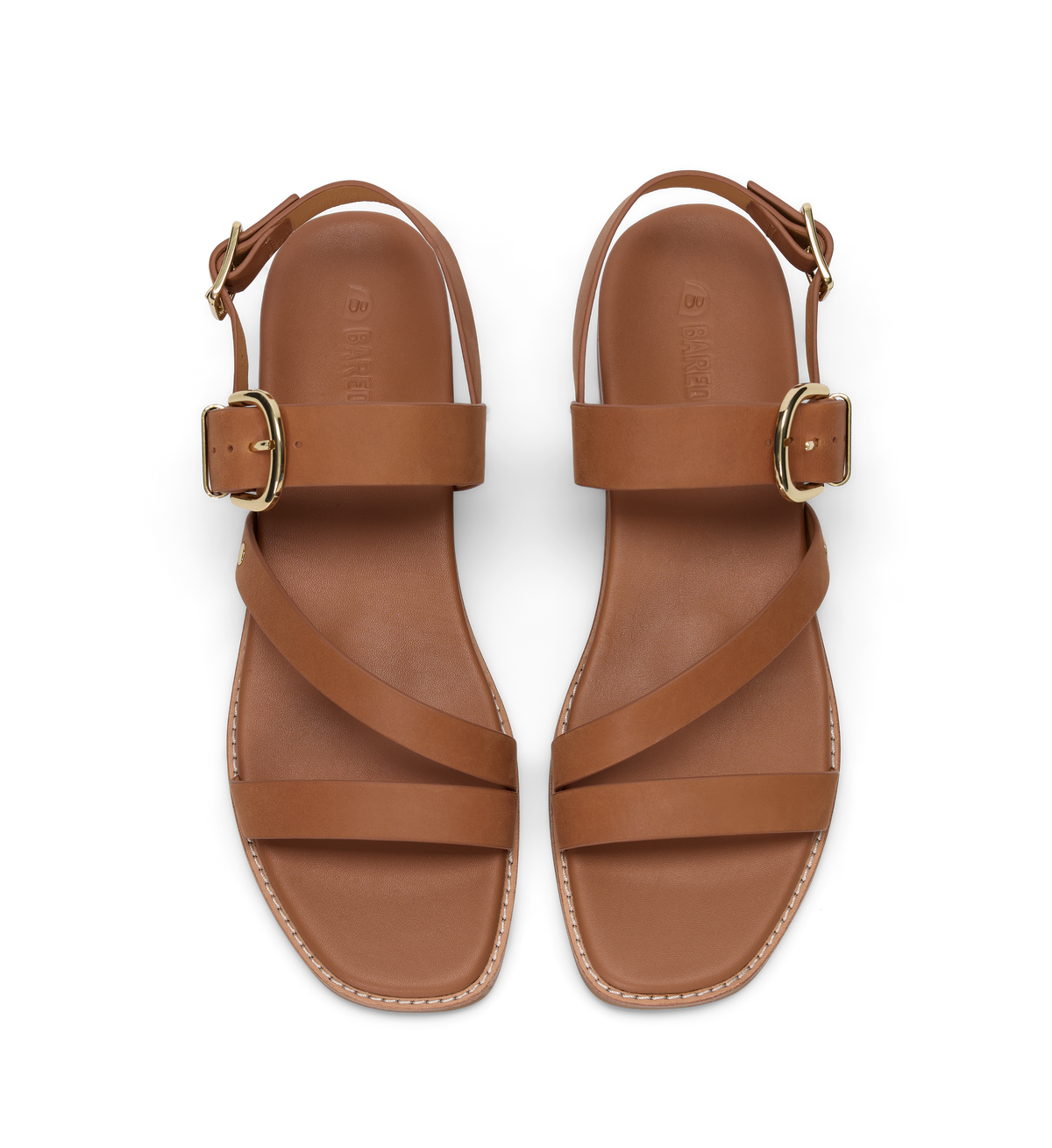 Pair of brown sandals with gold buckles on a white background