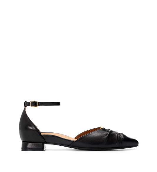 Black flat shoe with an ankle strap on a white background