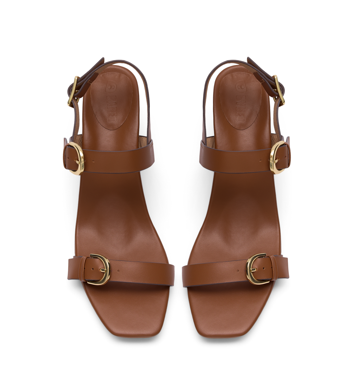Pair of brown heels with gold buckles on a white background