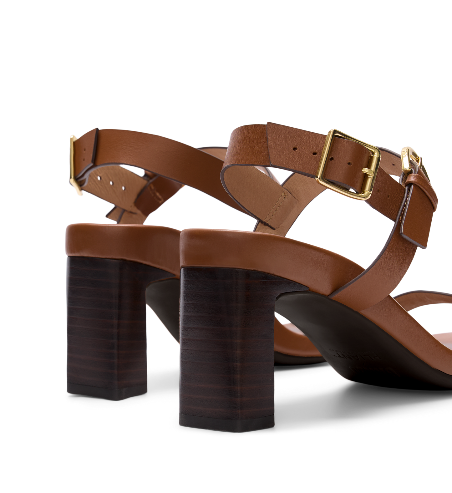 Brown leather sandals with block heels on a white background