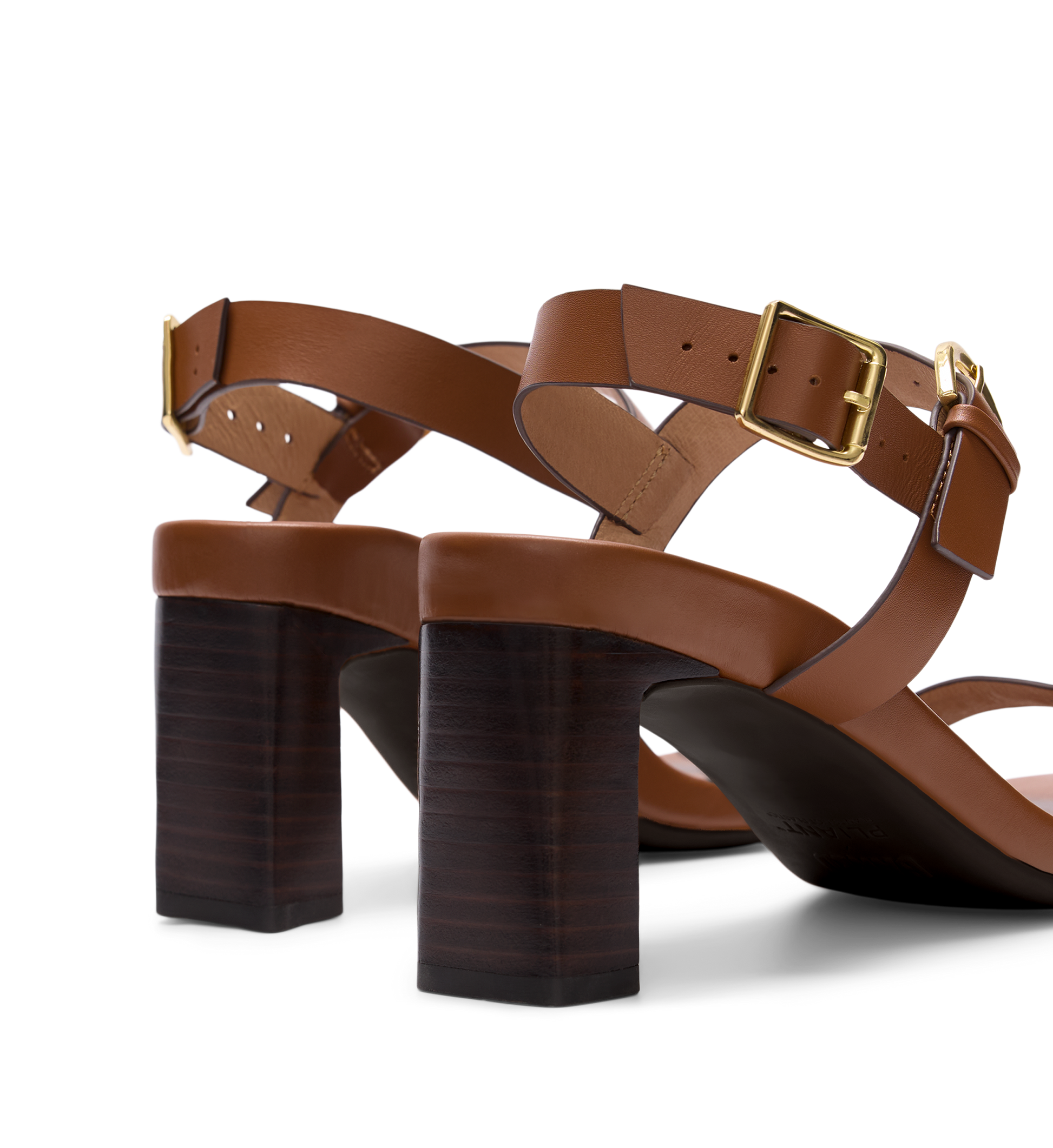 Brown leather sandals with block heels on a white background