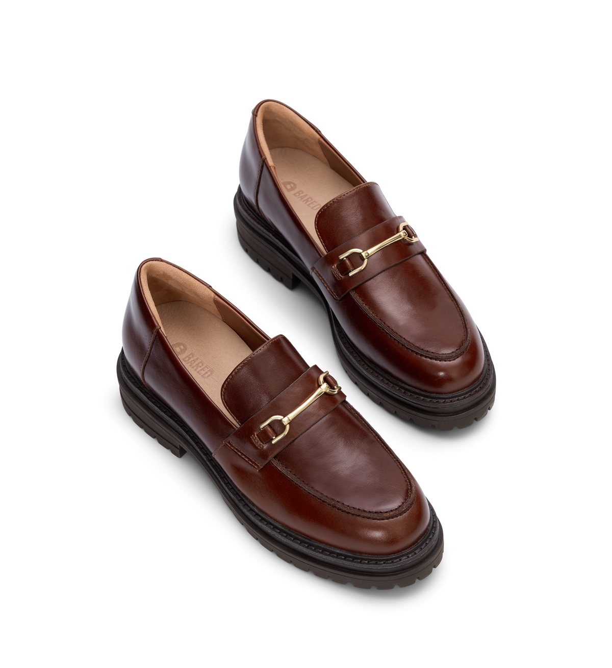 pair of womens tan loafers with chunky sole and gold hardware