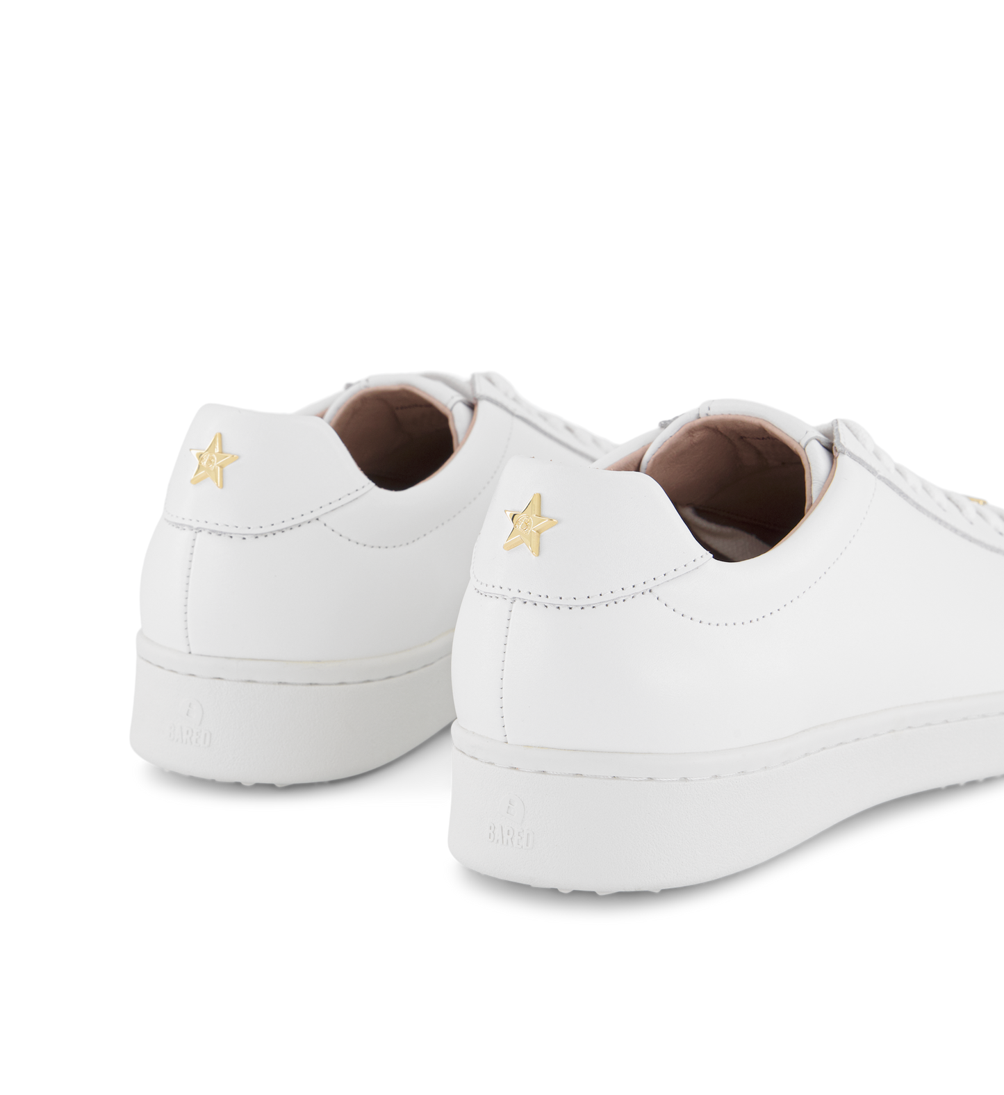 gold star detail on a pair of womens white sneakers