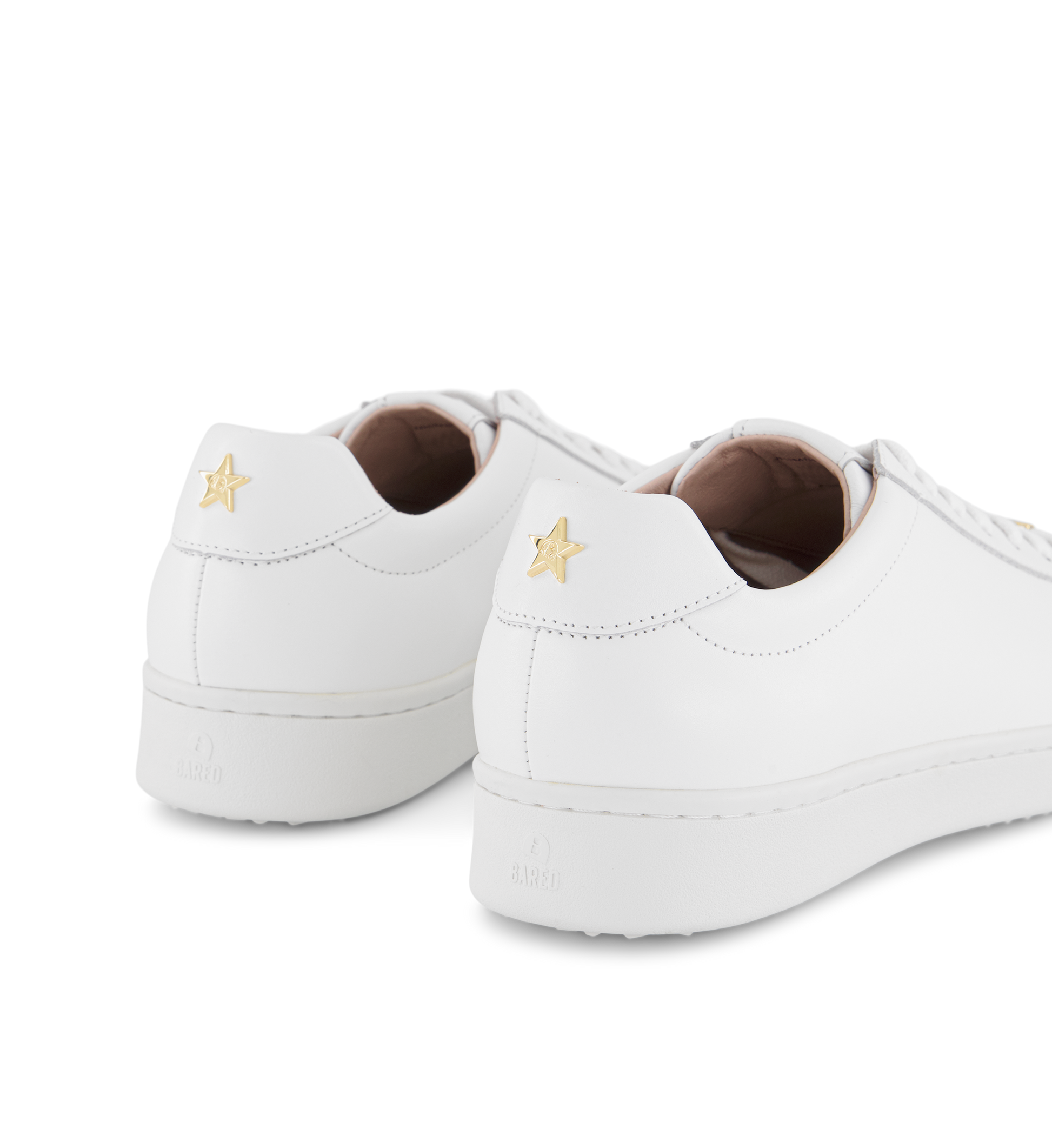 gold star detail on a pair of womens white sneakers