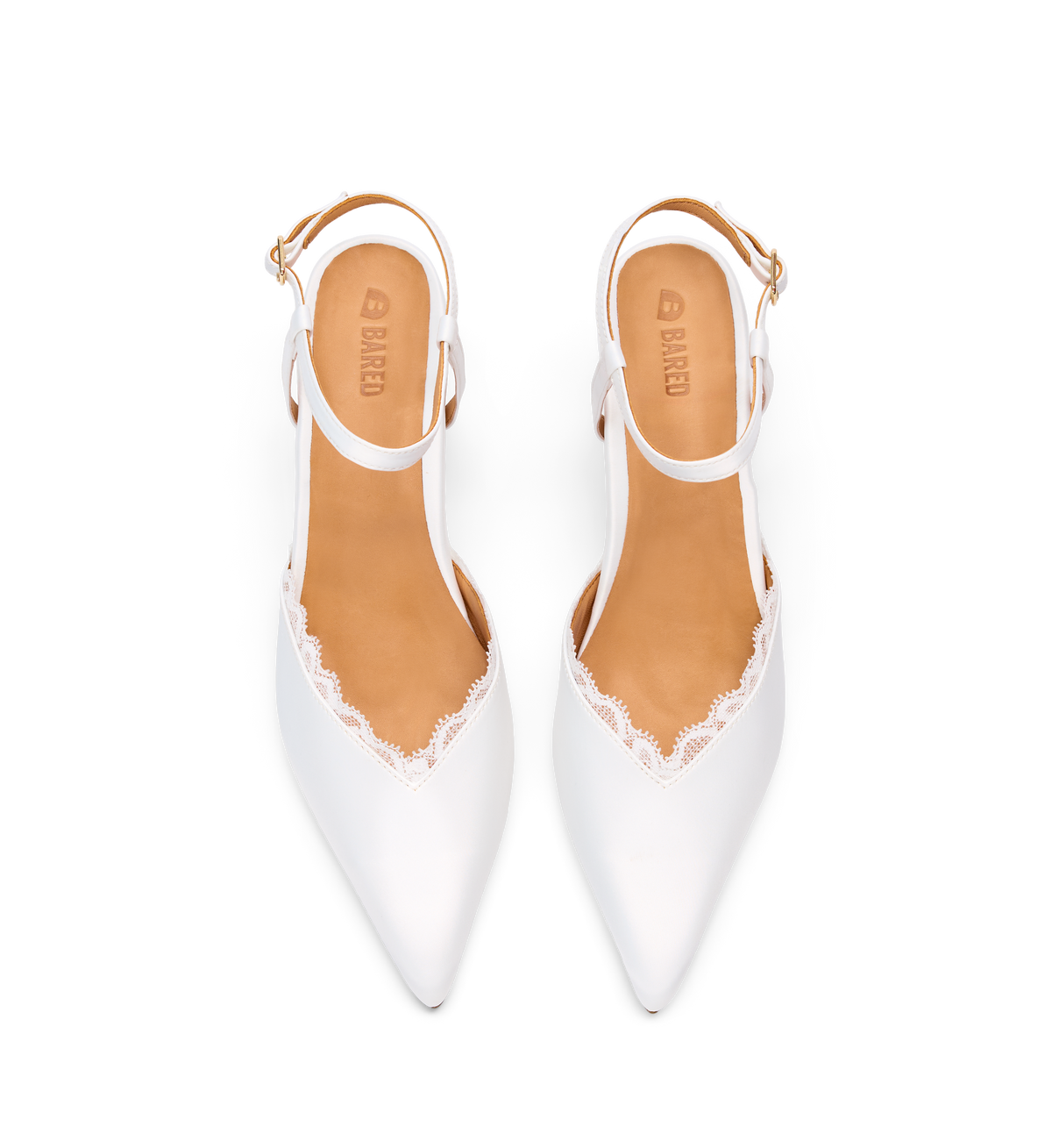 White pointed-toe shoes with lace details and tan soles on a white background