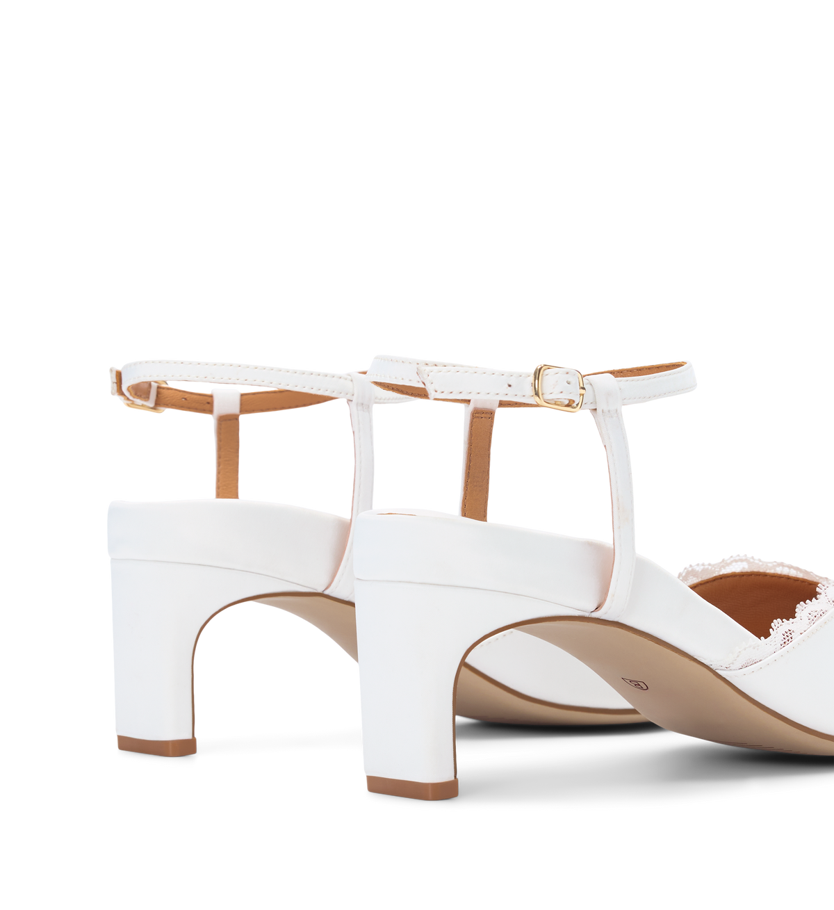White high-heeled shoes with brown soles on a white background