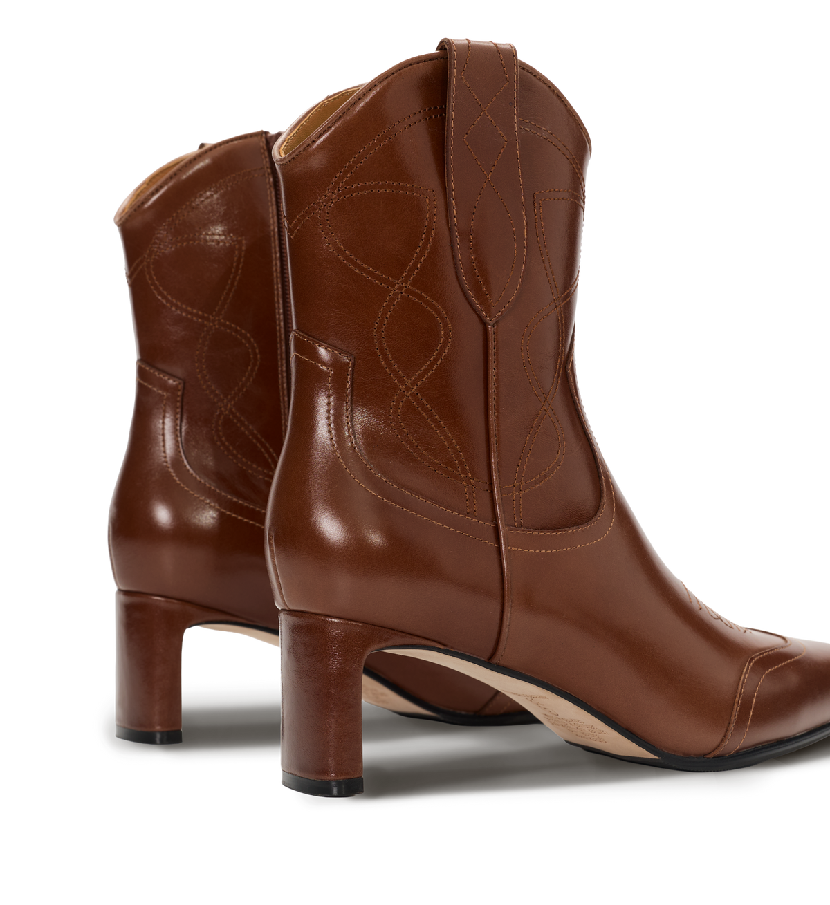 Brown leather cowboy boots on a white background