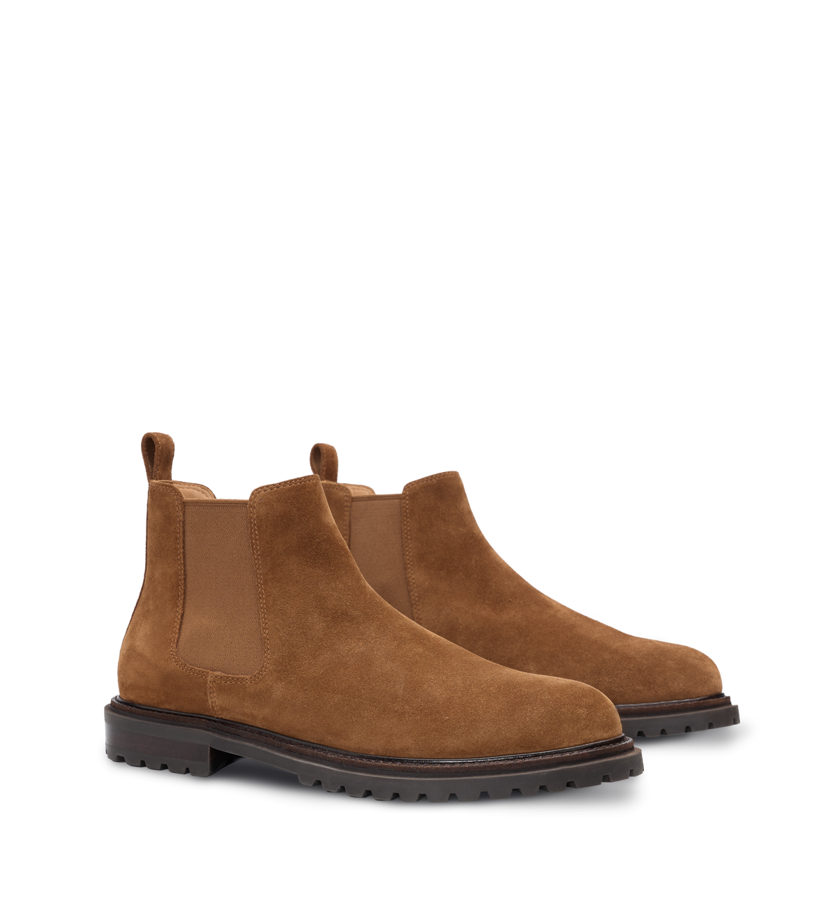 Pair of tan suede boots on a white background