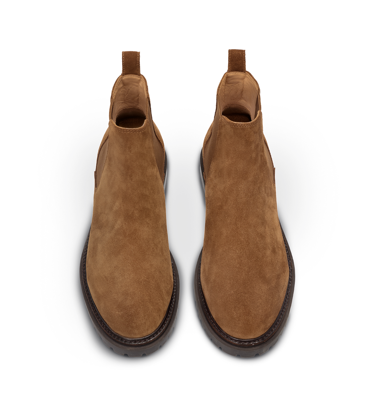 Pair of tan suede boots on a white background