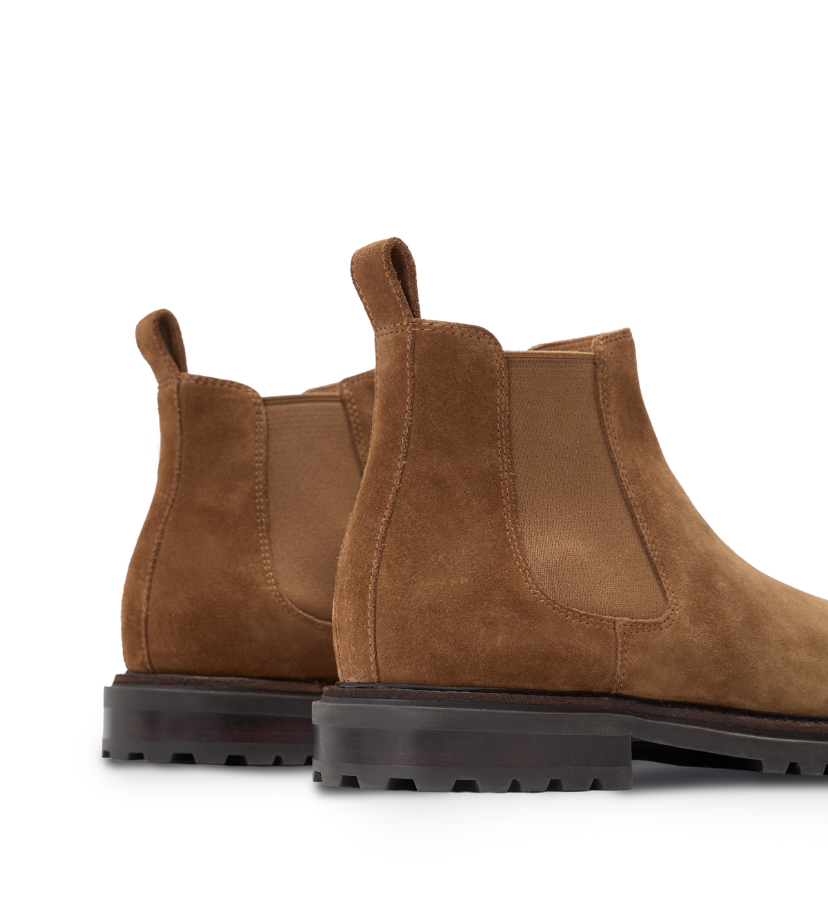 Brown suede Chelsea boots on a white background